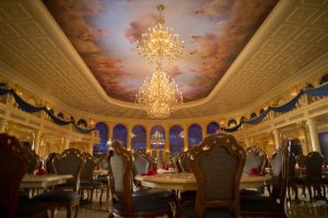 Decorated with a coffered, 20-foot ceiling with fluffy clouds and cherubs, the ballroom at Be Our Guest Restaurant features sparkling chandeliers designed to convey the elegance of the Beast's Castle in "Beauty and the Beast." Located in Magic Kingdom, the stylish restaurant will serve French-inspired cuisine for quick-service lunch and table-service dinner. Be Our Guest Restaurant is part of New Fantasyland at Walt Disney World Resort in Lake Buena Vista, Fla. (Matt Stroshane, photographer)